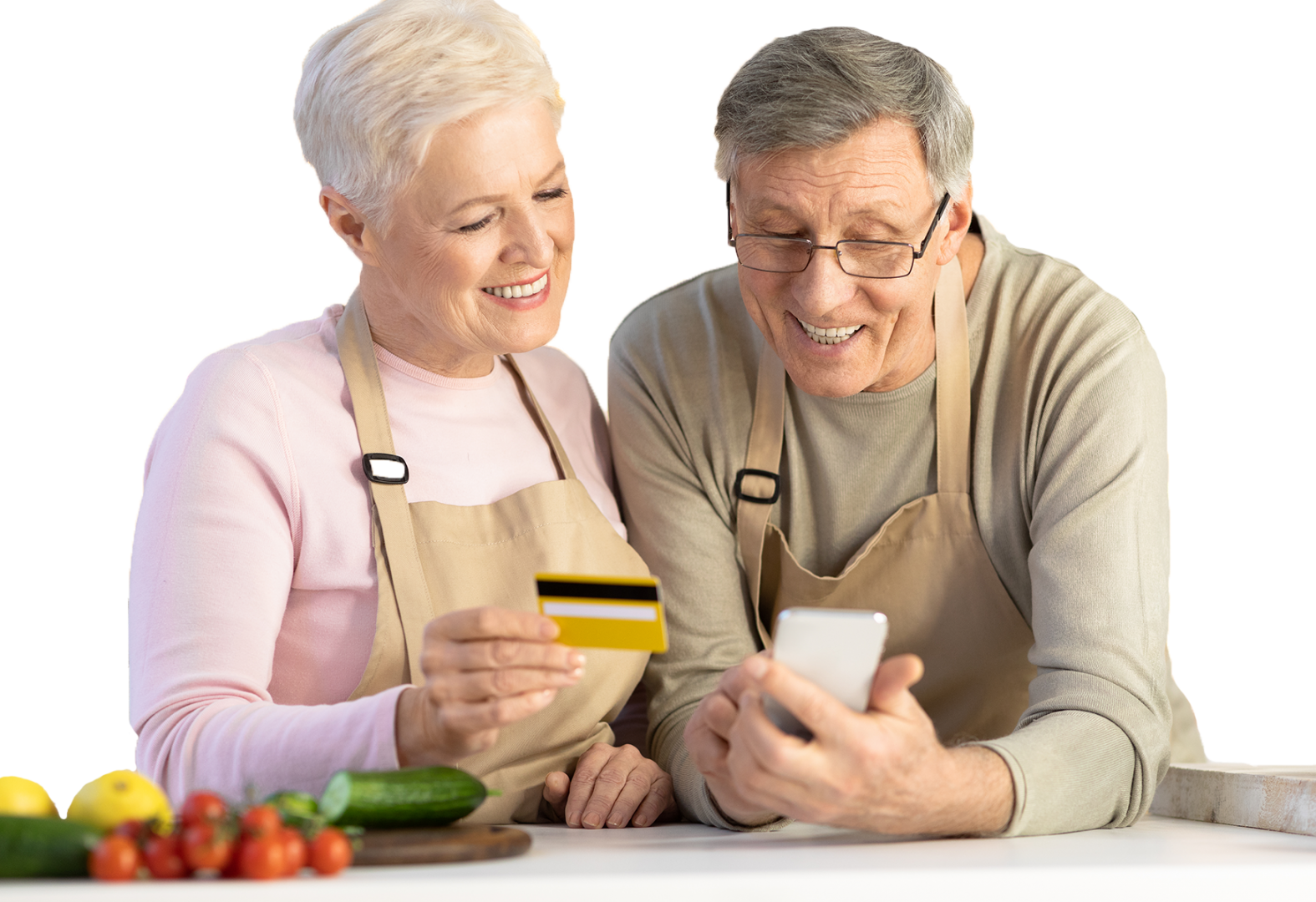 Senior couple smiling while buying something on their phone