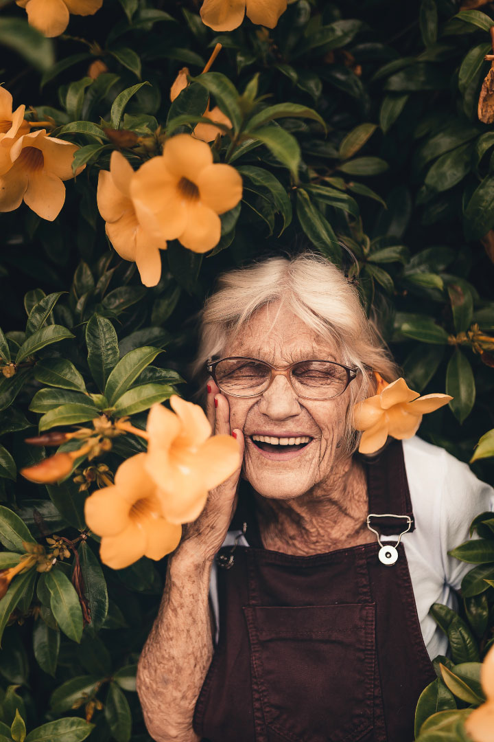 Smiling Older Lady With Flower